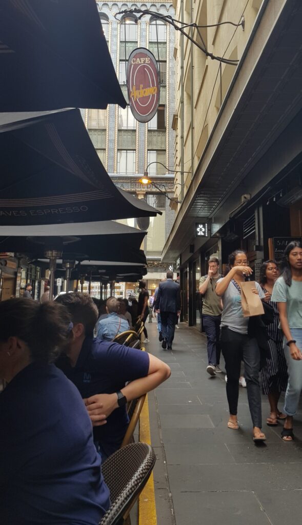 An image of the vibrant pulse of Degraves Street, Melbourne’s iconic laneway, celebrated for its rich coffee culture and lively alfresco dining scene